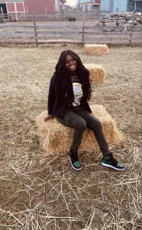 Young woman posing on a haystack, fall portrait